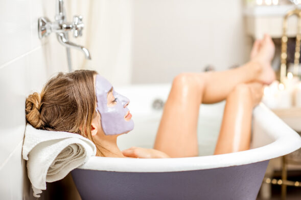 Woman with facial mask in the bathroom